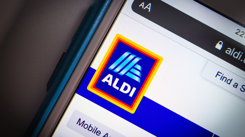 A close-up of the Aldi app shows the Aldi logo in the corner of the screen