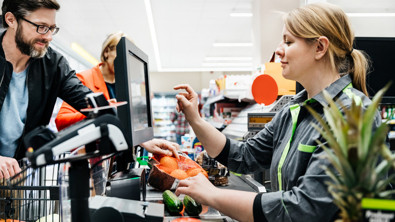 Someone paying for groceries at the grocery store