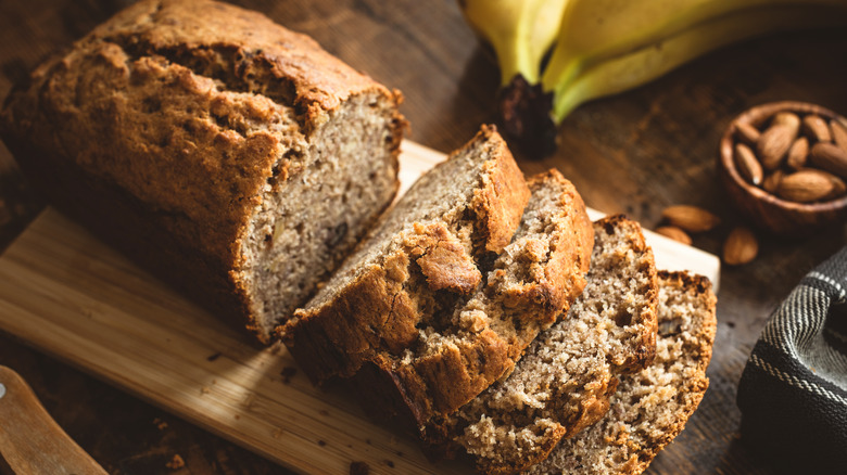 Loaf of banana bread sliced with bananas