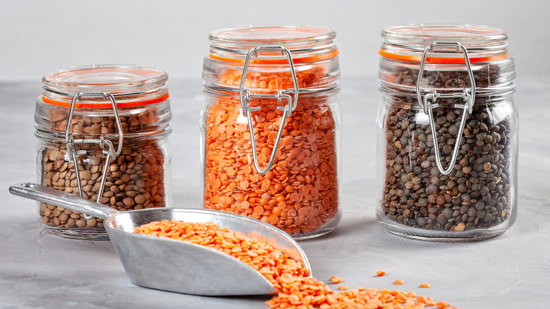 Jars of red, brown, and black lentils.