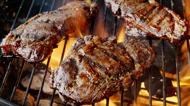 Three steaks on grill