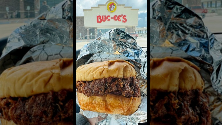 Fresh brisket sandwich unwrapped held in front of a Buc-ee's