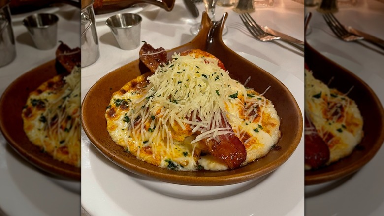 A platter filled cheese covered Texas toast, bacon, and more of a Hot Brown