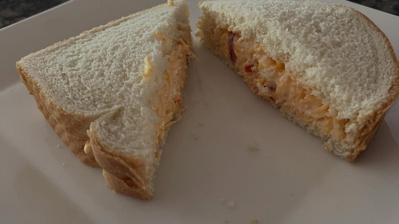 Simply plated pimento cheese sandwich cut diagonally