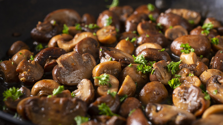 Mushrooms frying in skillet