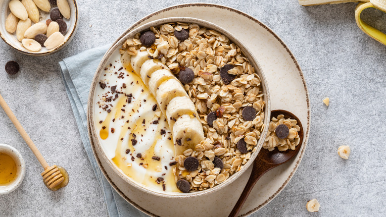 bowl of yogurt bananas chocolate chips and granola