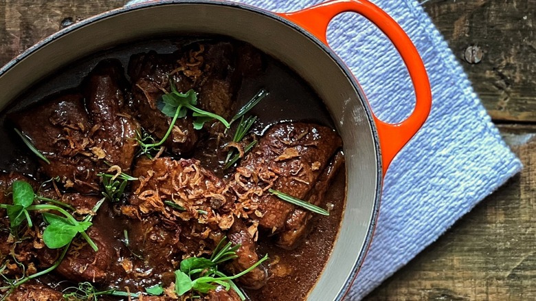 Brisket and herbs in a slow cooker