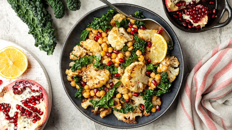 Roasted cauliflower tossed into a chickpea and kale salad with pomegranate.