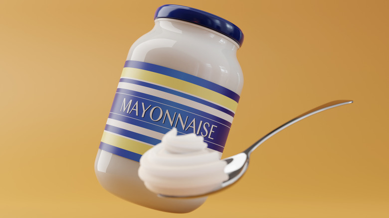 Jar and spoon of mayonnaise