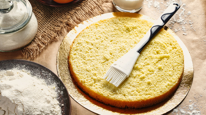 Sponge cake with brush on top surrounded by ingredients
