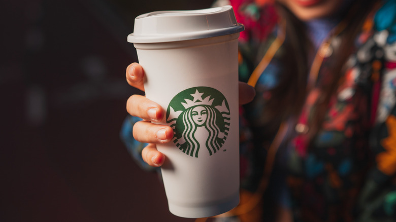 Person holding starbucks venti drink