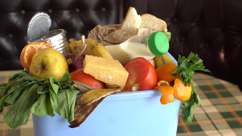Trash can overflowing with spoiled food