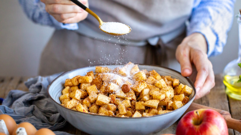 hands making apple pie filling