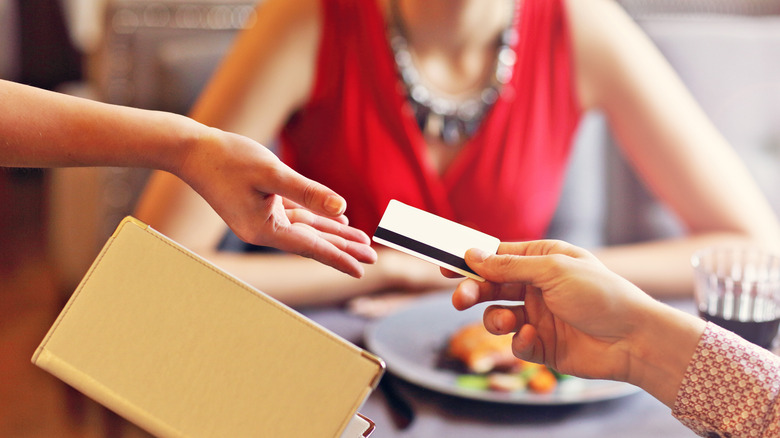 person paying with credit card