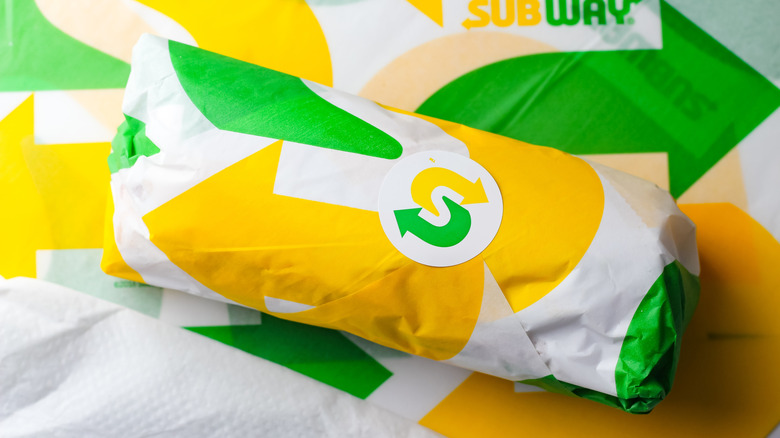 A wrapped Subway sandwich on paper.