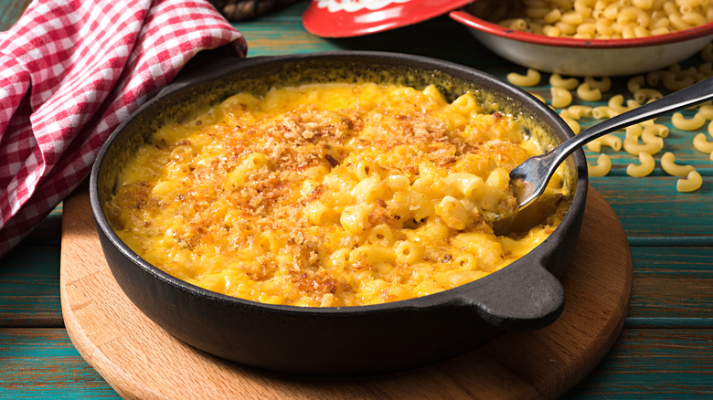 Macaroni and cheese in a cast iron serving dish, garnished with breadcrumbs