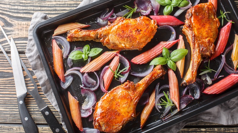 Roasted pork chops with rhubarb on baking pan