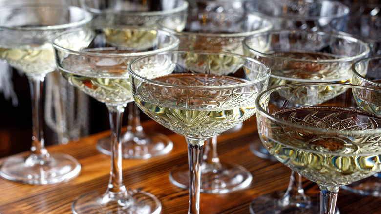 rows of coupe glasses on table