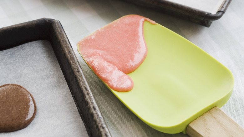 Curved spatula with batter on it
