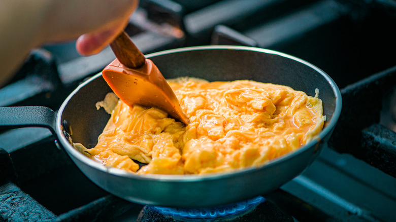 Stirring eggs in pan with spatula