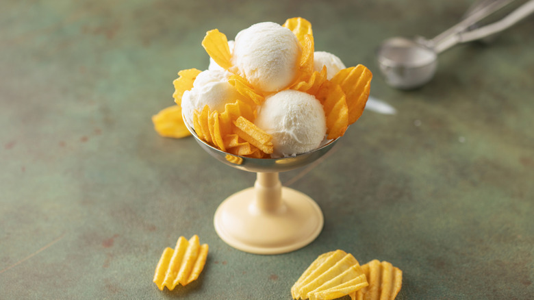 Vanilla ice cream scoops and ridged potato chips in a coupe glass.