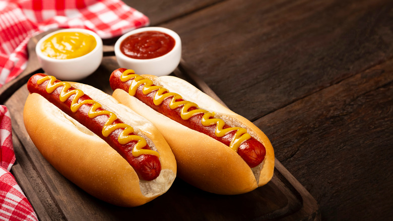 Two hot dogs with ketchup and mustard.