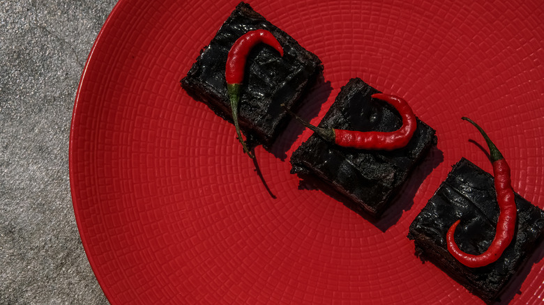 brownies on plate with chile peppers on top