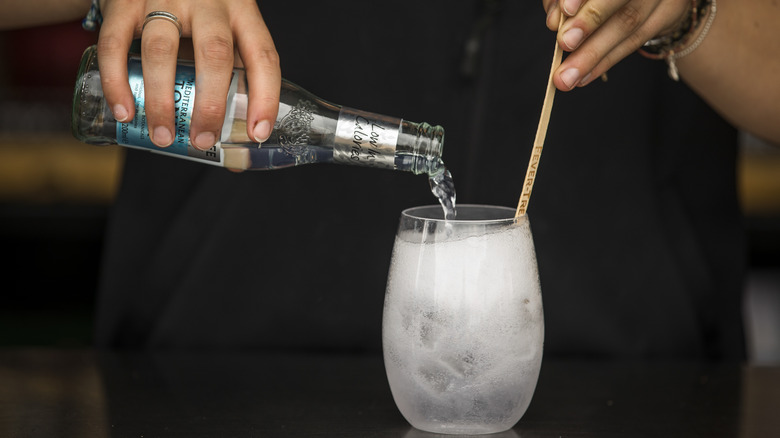 Bartender mixing a gin and tonic