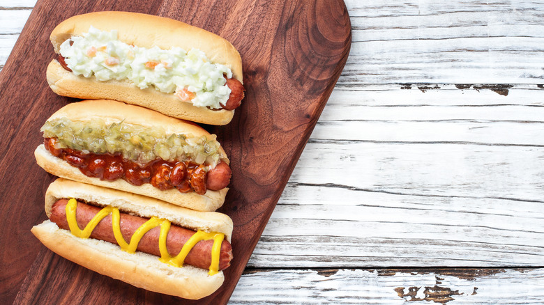 Three hot dogs with different toppings