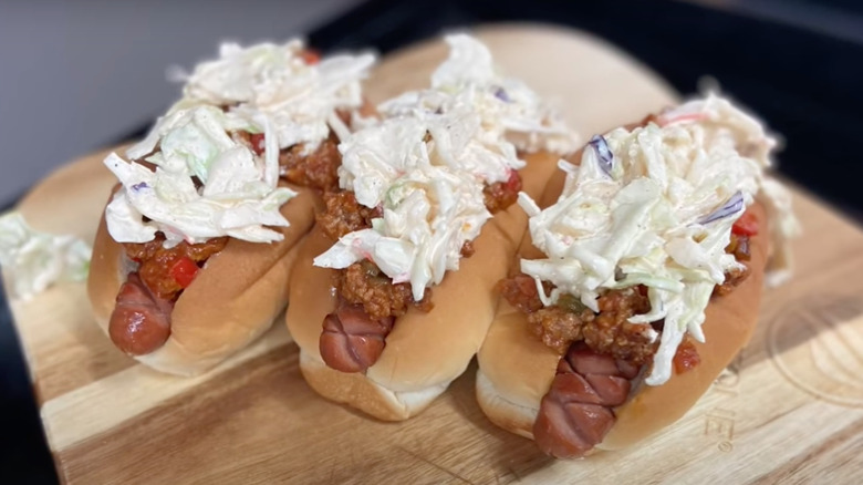 Chili slaw dogs on wooden cutting board