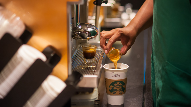 Barista making americano at Starbucks