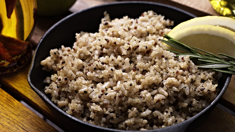 A bowl of quinoa and rice with lemon and rosemary