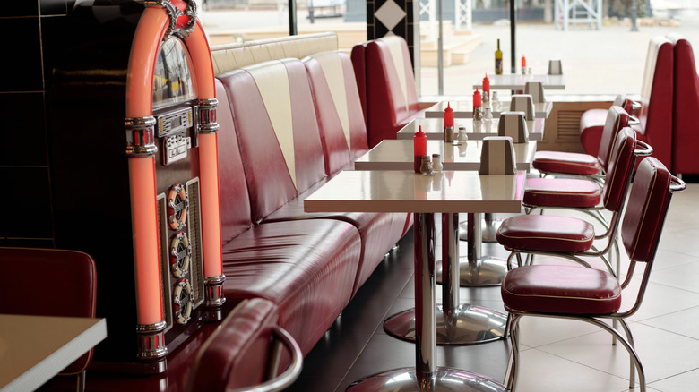 The interior of a retro diner with a jukebox.