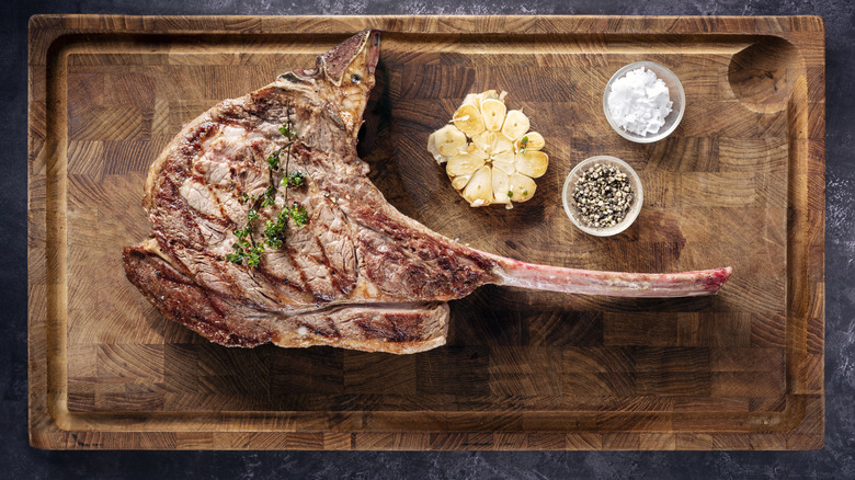 tomahawk steak on wooden board