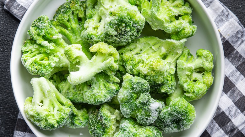 Frozen broccoli in white bowl