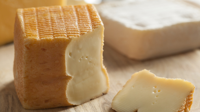 A block of Limburger cheese with wedge cut out