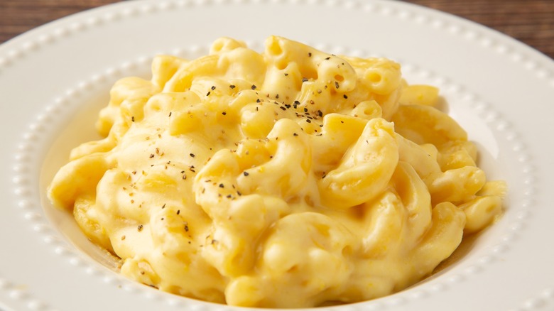 mac and cheese in bowl with black pepper on top