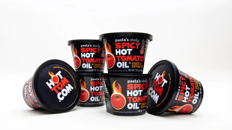 Jars of Hot Tom Pasta Daily's Spice Tomato Oil sauce on white background
