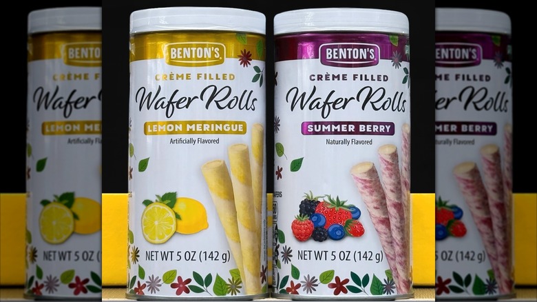 Two tins sit next to each other in Aldi, one of Lemon Meringue wafer rolls and the other of Summer Berry