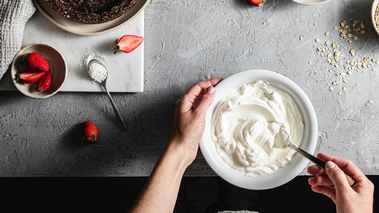 cook mixing whipped cream on counter
