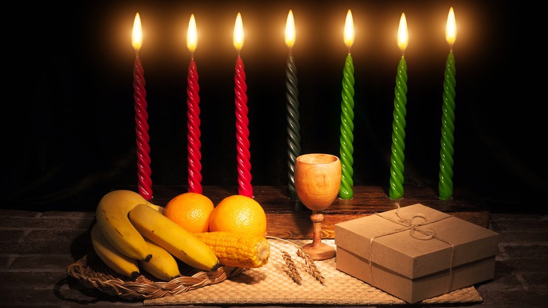 Seven symbols of Kwanzaa in front of candles