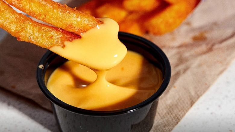 Taco Bell fries dipped into its Nacho Cheese Sauce