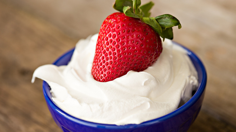 whipped cream in bowl with strawberry