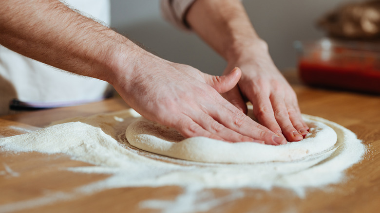Stretching pizza dough by hand