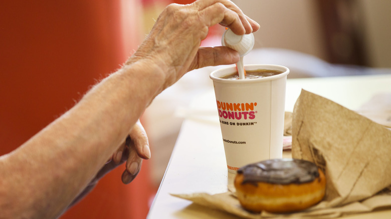 Adding creamer to coffee