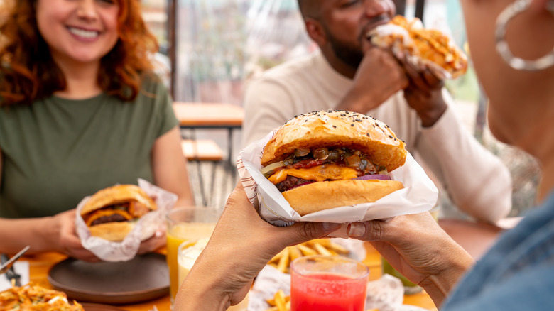 Friends enjoying their burgers at a resturant