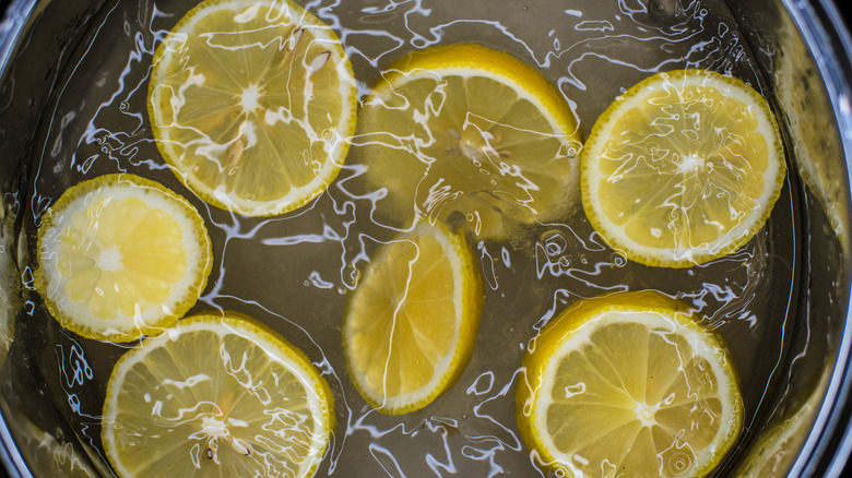 Citrus peels simmering in a saute pan