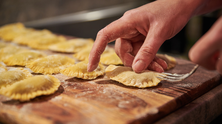 pressing handmade ravioli with a fork