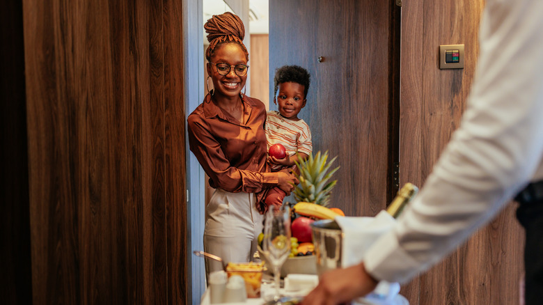 Hotel guest receiving room service tray