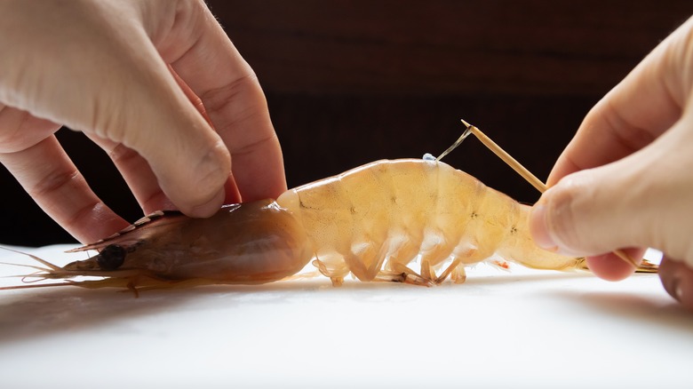 Deveining a shrimp with a toothpick